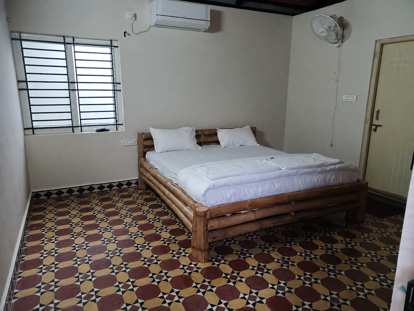 Air-conditioned guest room with a handcrafted wooden bed